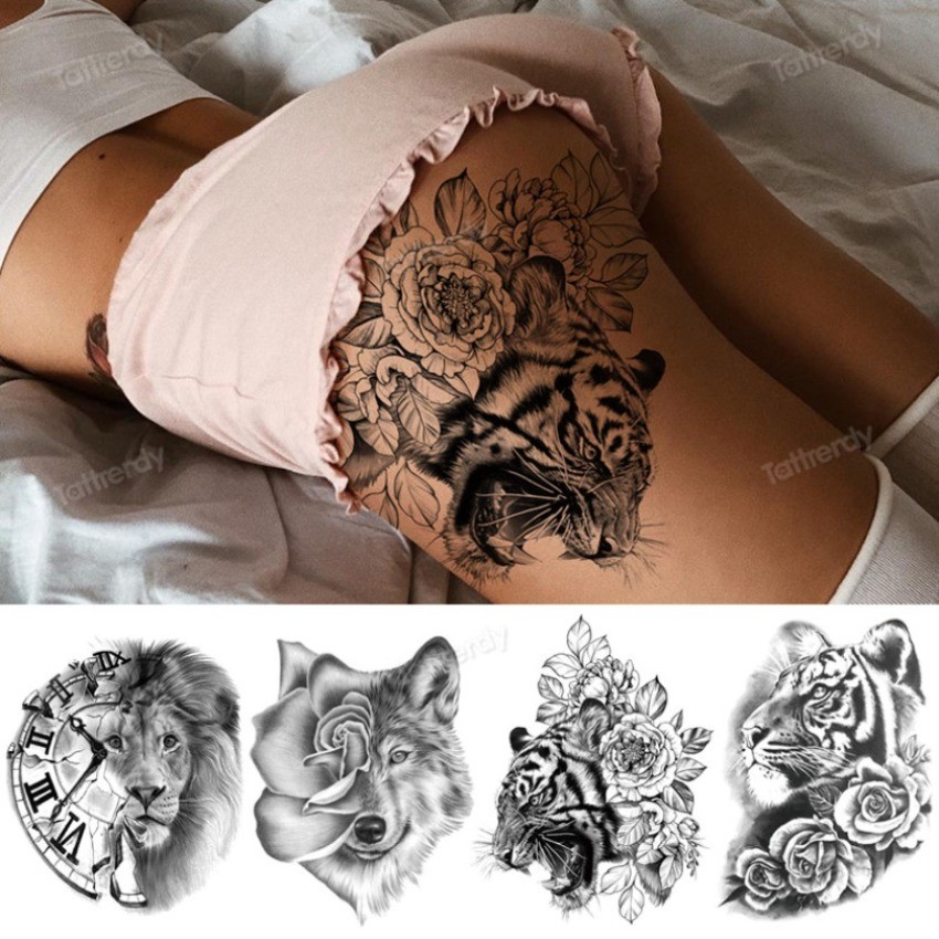 tatuagem feminina na coxa com flores